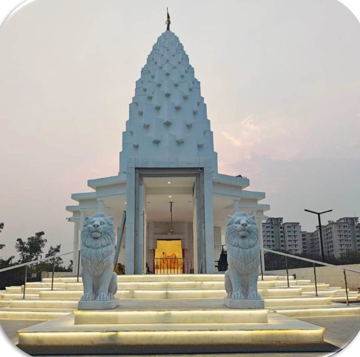 Shridham Radha Krishna Temple illuminated at dusk